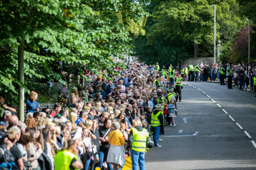 Photo shows a very large crowd lining the road to Brechin Castle.