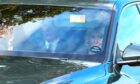 King Charles III is pictured driving through Ballater following the Queen's funeral.