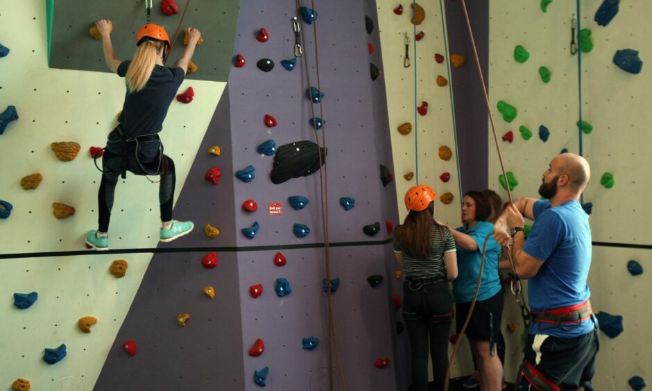 Children using a climbing wall in Angus