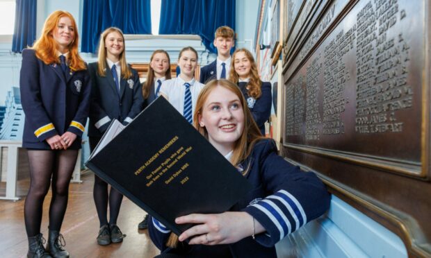 Head girl Jess Short peruses some of the names on the war memorial with (from left) Sophie Evans, Charlotte Fraser, Hanna Braithwaite, Nuala Maclennan, Rory Dent and Olivia Dewar. Pictures by Kenny Smith/ DCT Media
