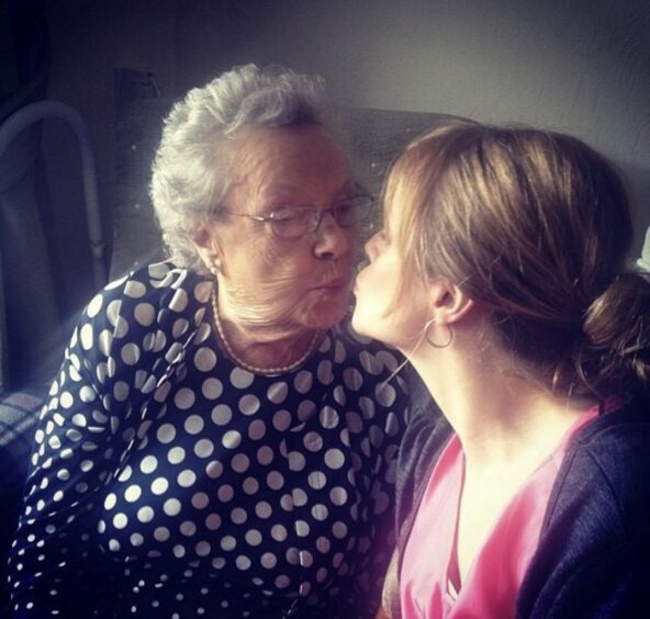 photo shows Lindsay Bruce and her grandmother kissing at her grandmother's 90th birthday party.