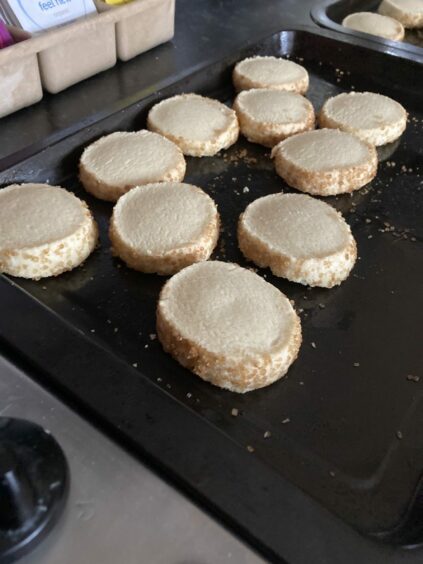 Photo shows an oven tray with freshly-baked shortbread from the author's family recipe book.