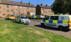 Police vehicles and an ambulance on Cullen Place, Dundee.