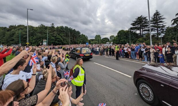 Huge crowds watch the Queen's Cortege on the Kingsway at the Swallow Roundabout. Image: Richard Prest.