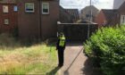 A police officer on Lilybank Terrace on Friday.