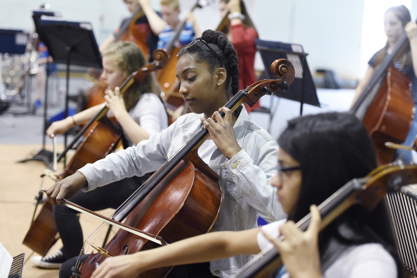 Children playing cello in an orchestra in Scotland.