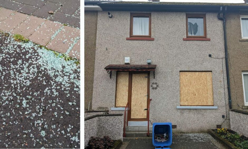 Image shows shattered glass on the pavement and a terraced house with boarded up doors and windows in Craigmore Street, Dundee.