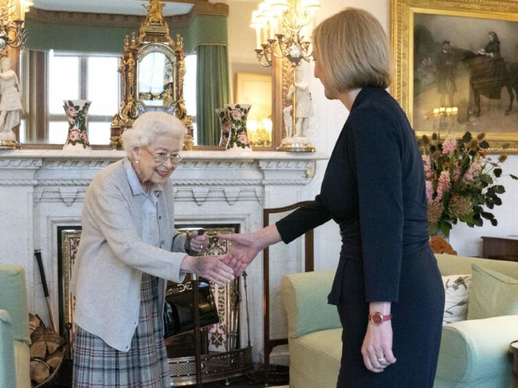 Photo shows the Queen shaking hands with new prime minister Liz Truss in a lavishly decorated room at Balmoral Castle.