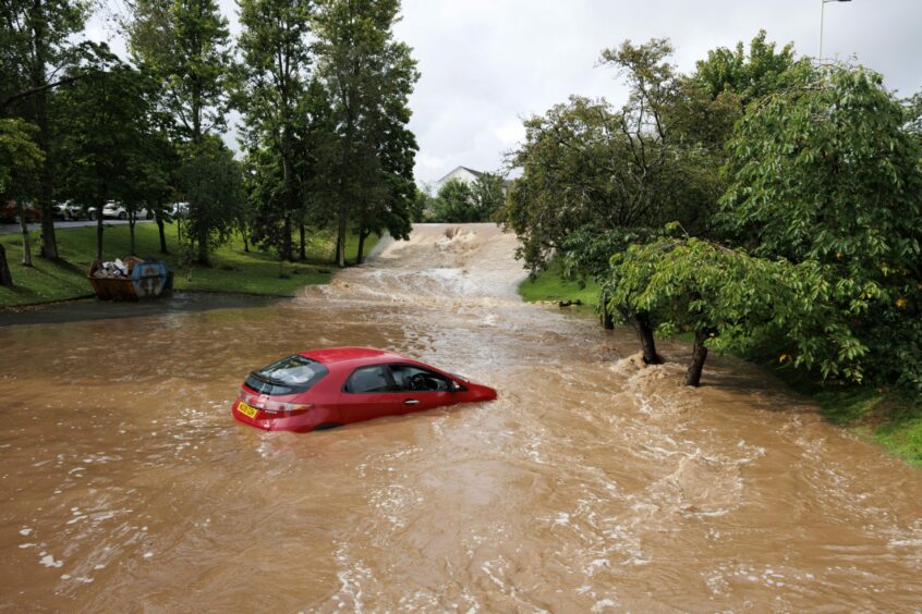 Car in several feet of water in car park of Perth's Cherrybank Inn