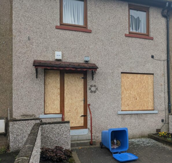 Windows at the home on Craigmore Street, Dundee, were smashed during the protest.