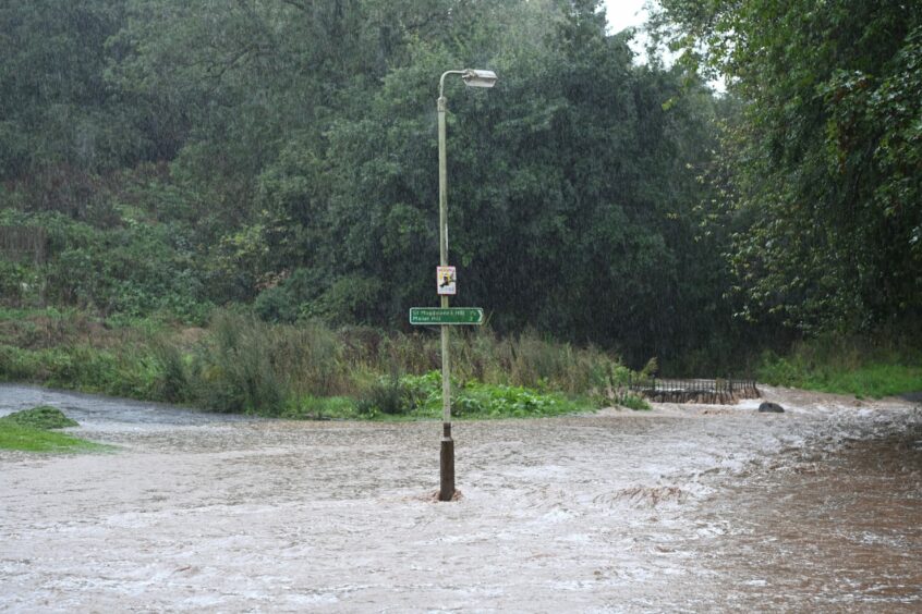 Lamp post in deep floodwater near entrance to Craigie Hill Golf Club, Perth