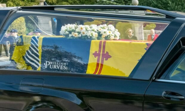 The Queen's coffin cortege passing all the dignitaries at Duthie Park in Aberdeen - with the logo on show.