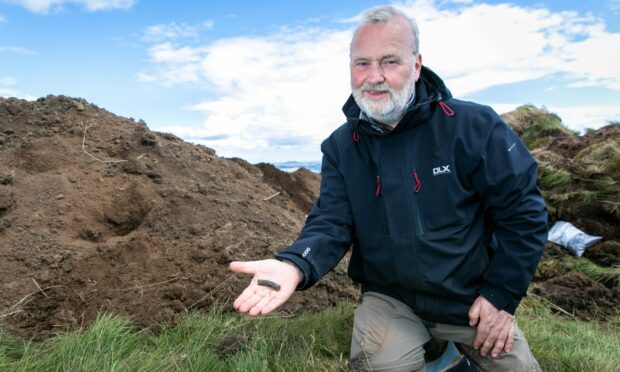 Joe Fitzpatrick, co-director Falkland Centre for Stewardship, with part of a shale bracelet dated range 1500-2500 yrs old