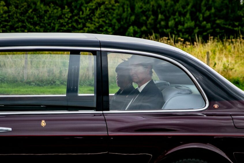 Princess Anne and Sir Timothy Laurence in a car during the procession