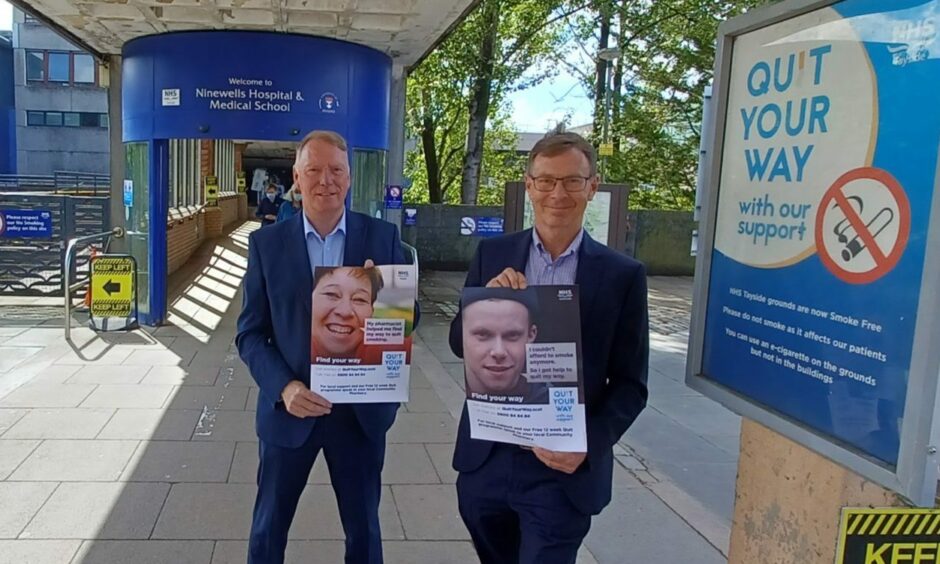photo shows two representative of NHS Tayside, Billy Alexander and Dr Andrew Ridley, in front of the main entrance to Ninewells Hospital, Dundee, with posters explaining that a new smoking ban has come into force outside NHS hospital buildings in Scotland.