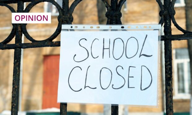 photo shows a sign saying 'school closed' on a school gate.
