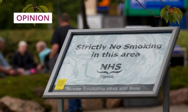 photo shows an NHS Tayside sign advising people there is 'strictly no smoking in this area'