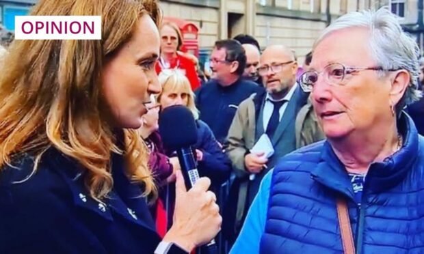 photo is screengrab from a television news report showing the presenter Martel Maxwell interviewing a woman waiting to pay her respects to the Queen in Edinburgh.