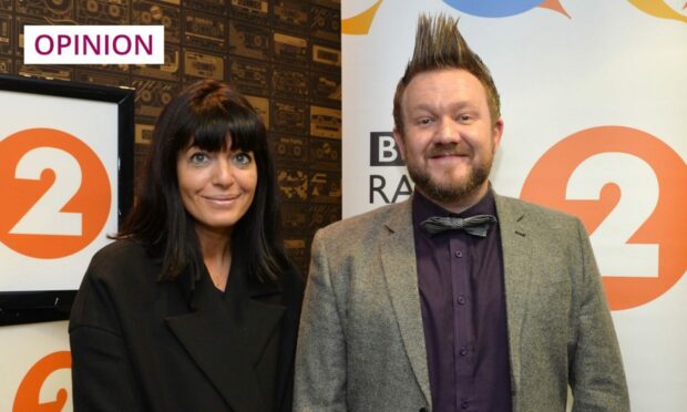 photo shows the writer Tommy Small with the TV presenter Claudia Winkleman, standing in front of signs for BBC Radio 2.
