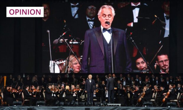 photo shows Andrew Bocelli on stage at an outdoors performance in Inverness