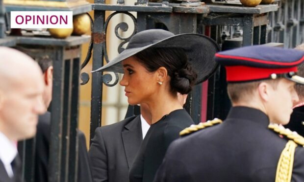 photo shows Meghan Markle in a black outfit and hat at the Queen's funeral.