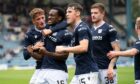 Dundee celebrate with goalscorer Zach Robinson against Queen's Park.