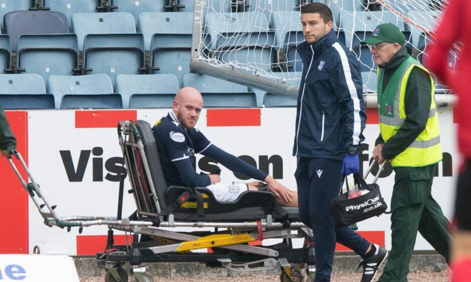 Dundee striker Zak Rudden on a stretcher after suffering injury against Queen's Park.