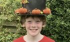 Stewart Hedderman modelling an autumn-themed top hat in Falkland