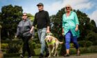 Greg Christie with his guide dog Baxter and Carol Wood (left) and Hazel Reid (right).