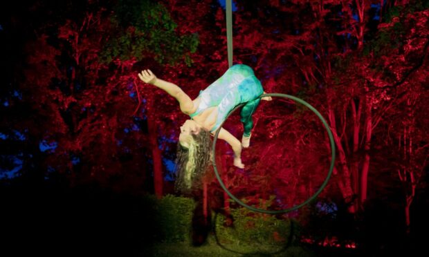 An acrobat practices the aerial performance at Dundee Botanic Garden.