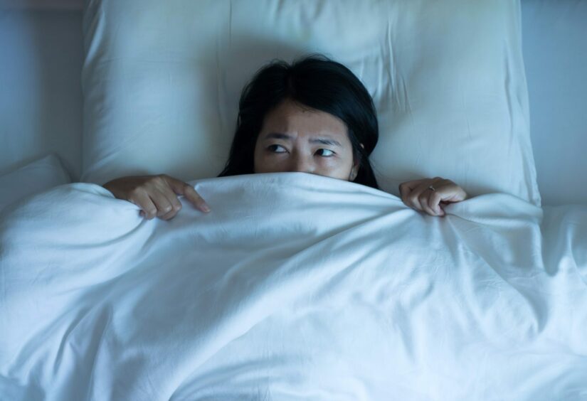 a woman experiencing night terrors in bed