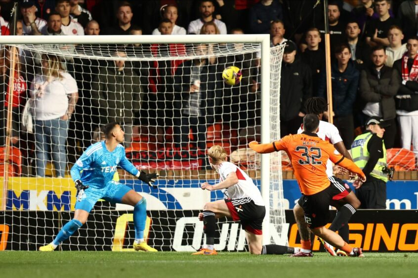 Tony Watt fires past Kelle Roos to grab his third Dundee United goal.