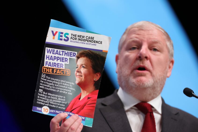 Photo shows Angus Robertson, Cabinet Secretary for the Constitution, External Affairs and Culture, holding a leaflet titled "The New Case for Independence"