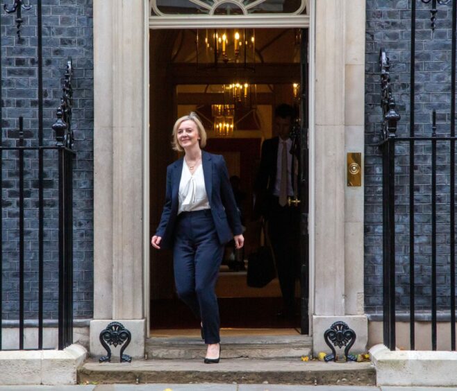 Photo shows Liz Truss walking out of 10 Downing Street.
