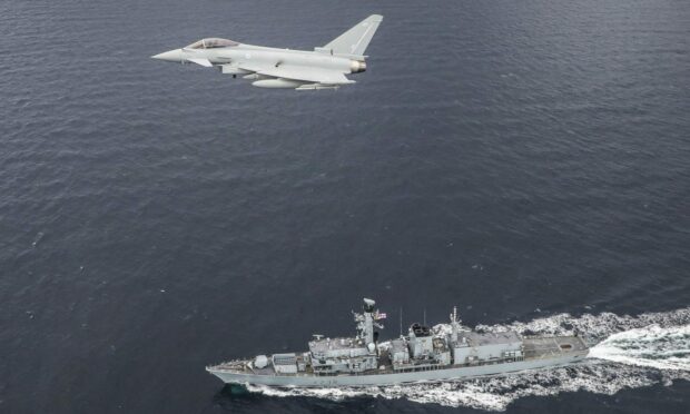An RAF Typhoon aircraft and Royal Navy frigate in action on the North Sea.
