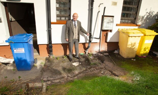 Stan Garland with the damaged water pipe. Image: Paul Reid