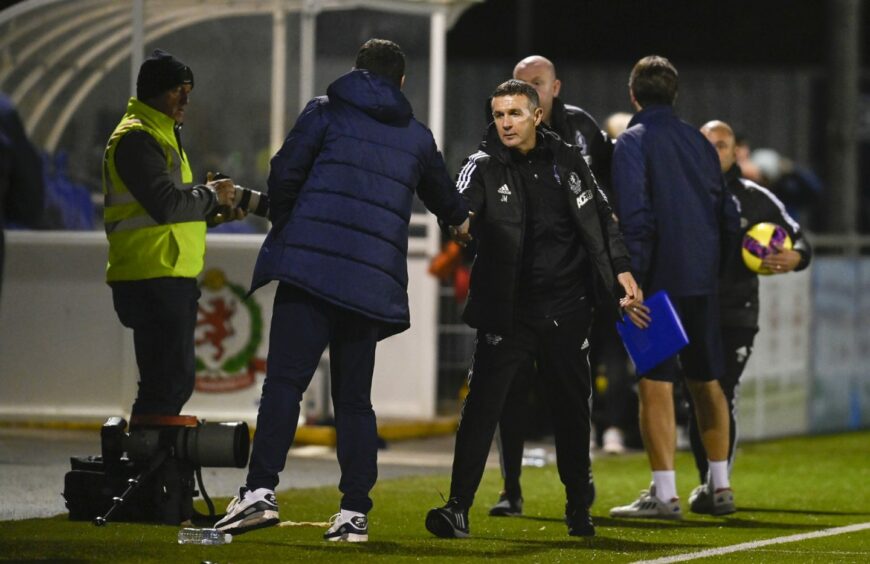 Current Dundee manager Gary Bowyer shakes hands with former Dee boss Jim McIntyre.