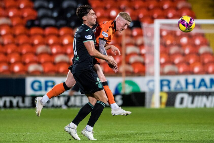 Dundee United's Craig Sibbald battles Joe Newell of Hibernian.