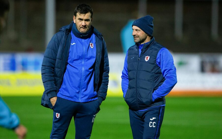 Raith Rovers assistant Colin Cameron and manager Ian Murray hold discussions on the pitch before a game.