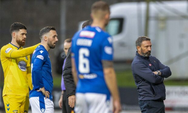 Waiting game - managers and players wait for Craig Napier to determine whether James Brown was going to be sent off.