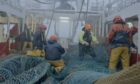 Trawlermen: Hunting the Catch: Crew work to repair the nets on Endeavour V, 200 miles off into the North Atlantic.
