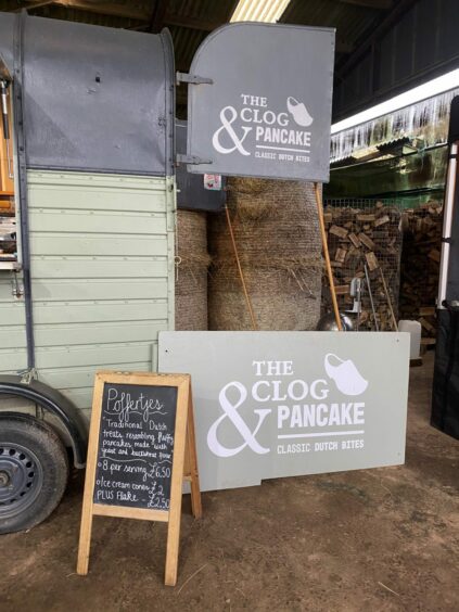 Photo shows a food trailer with a sign for The Clog and Pancake catering company.