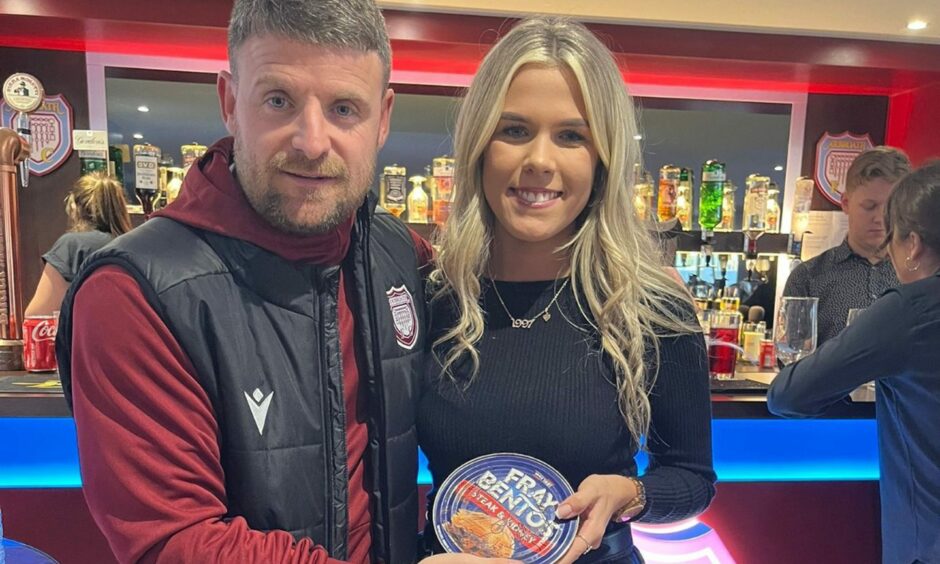 Bobby LInn presents Lois with her signed Fray Bentos pie