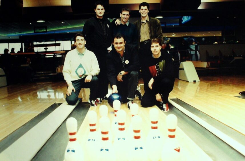 Photo shows six Dundee FC players, in 1990s fashions, at the end of a tenpin bowling alley