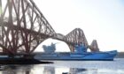 HMS Prince of Wales goes under the Forth Bridge in Fife