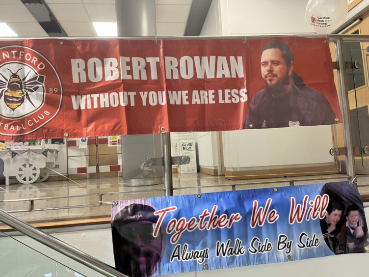 A banner hung in memorial to Robert Rowan who died suddenly in 2018.