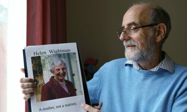 Alan Wightman with a photograph of his mum Helen, who died after being infected with coronavirus