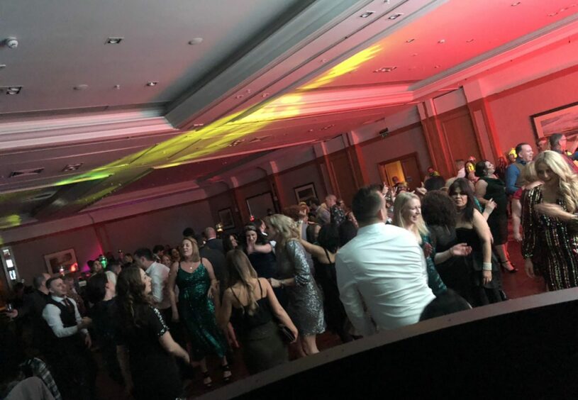 photo shows a packed dancefloor taken from the DJ booth.