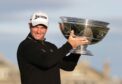 Ryan Fox lifts the trophy after winning the Dunhill Links.