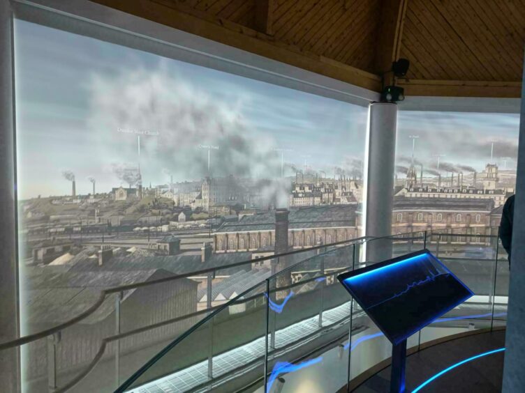 Photo shows an artist's impression of Dundee at the dome experience, featuring factory chimneys pumping out thick smoke.